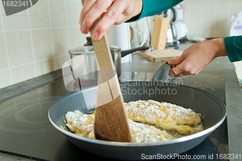 Image of chef frying salmon steak