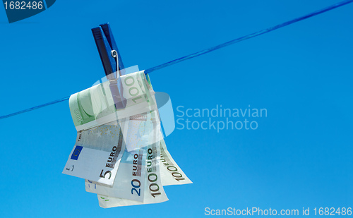 Image of euro money banknotes hanging on clothesline