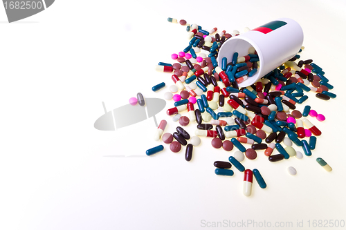 Image of pills spilling out of container 