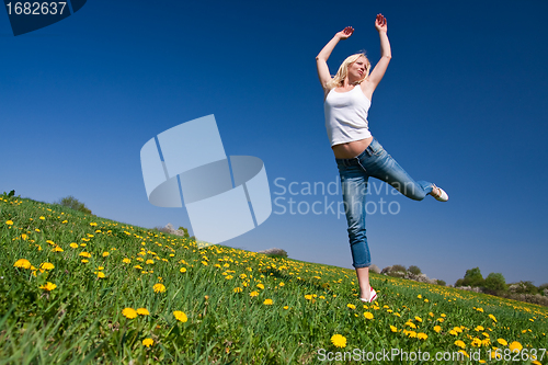 Image of happy young woman on meadow