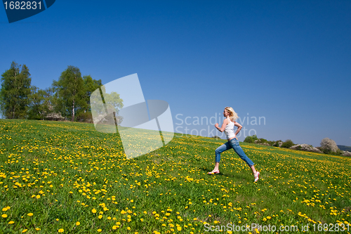 Image of happy young woman on meadow