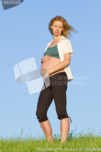 Image of pregnant woman on meadow