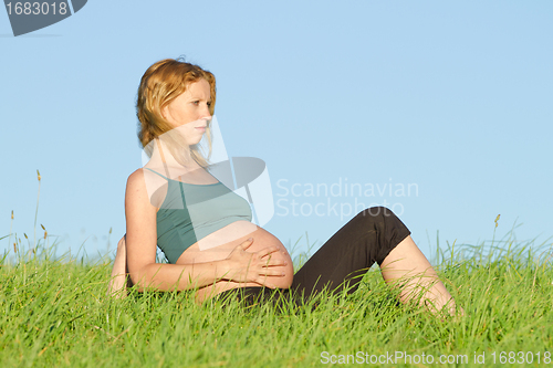 Image of pregnant woman on meadow