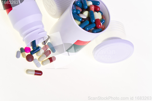 Image of pills spilling out of container 