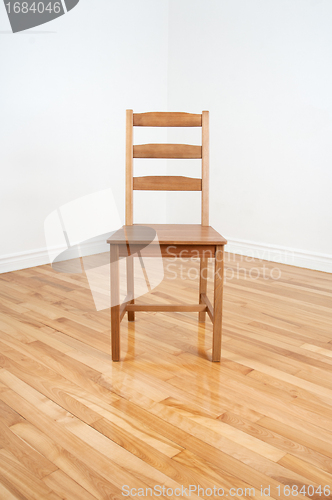 Image of Wooden chair in the corner of a room