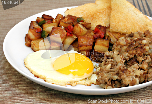 Image of Fried egg, home fries and hash breakfast.