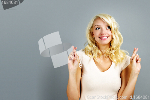 Image of Happy woman crossing fingers