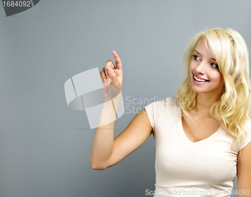 Image of Happy young woman pointing