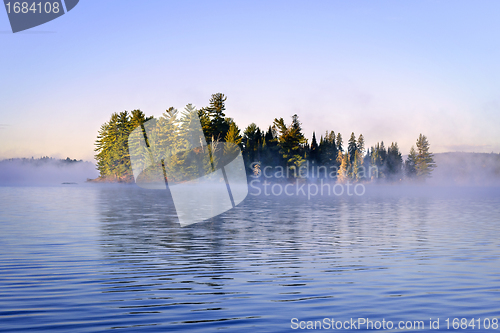 Image of Island in lake with morning fog