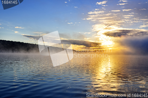 Image of Sunrise on foggy lake