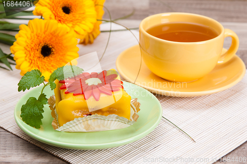 Image of tea with cake and gerberas flowers