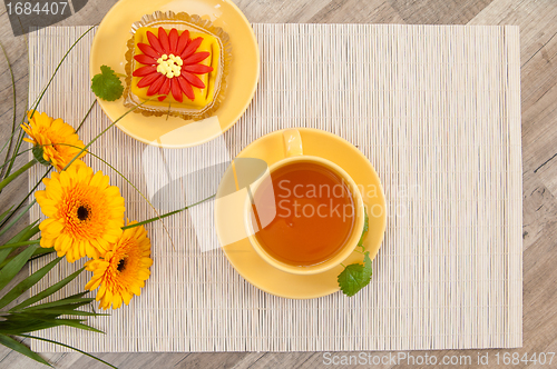 Image of tea with cake and gerberas flowers