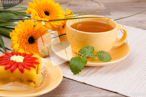 Image of tea with cake and gerberas flowers