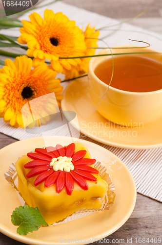 Image of tea with cake and gerberas flowers