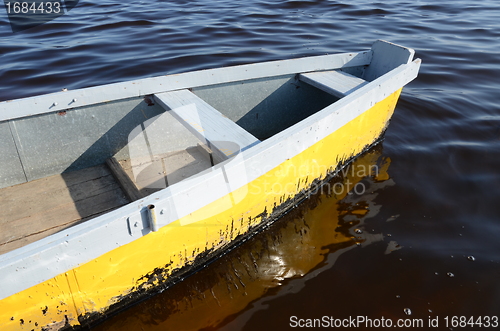 Image of wooden scull rowboat ripple water. water transport 