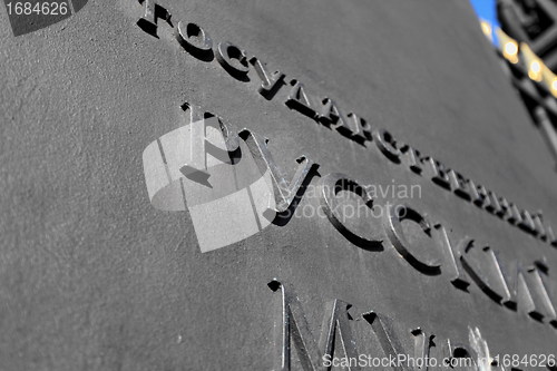 Image of cast-iron plate with the letters