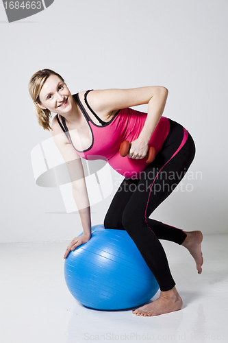 Image of Pregnant woman exercising with dumbbells