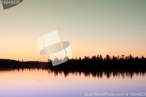 Image of sunset over lake in forest