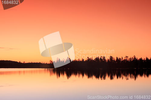 Image of sunset over lake in forest