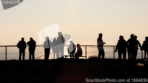 Image of Silhouettes of people at the fence