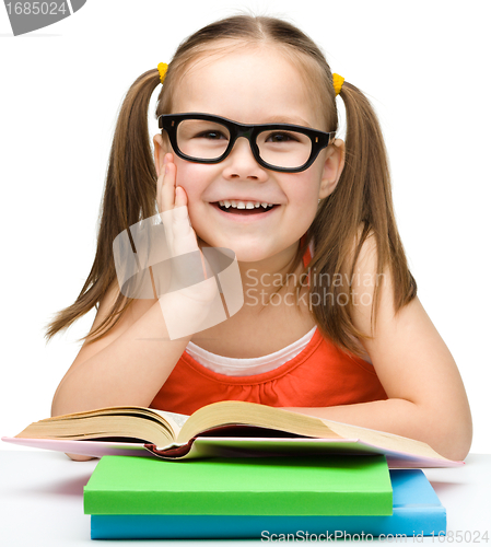 Image of Cute little girl with books