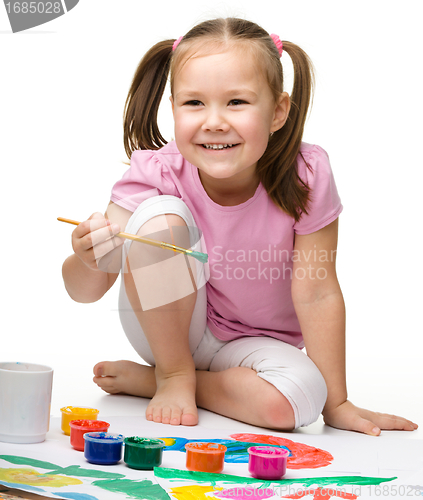 Image of Cute cheerful child play with paints