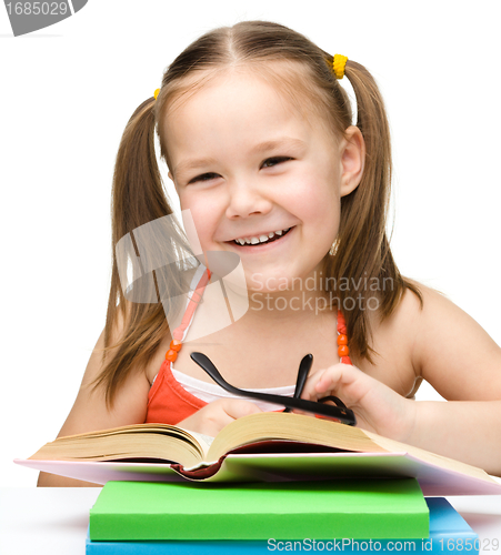 Image of Cute little girl with books