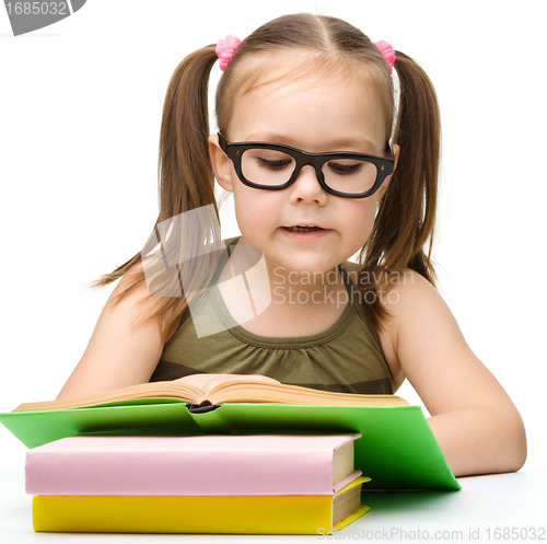 Image of Cute little girl reading book