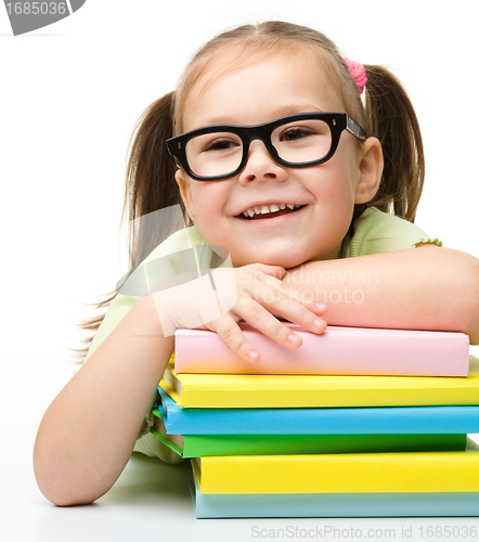 Image of Cute little girl with books