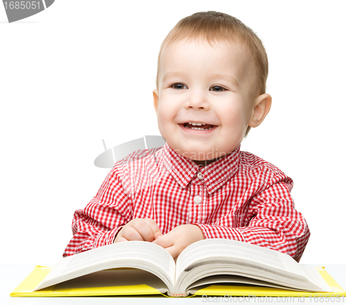 Image of Little child play with book