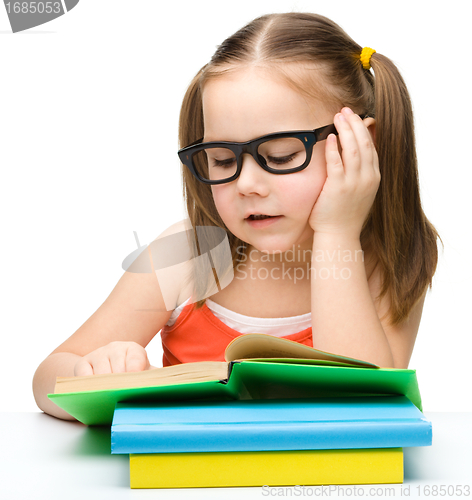 Image of Cute little girl reading book