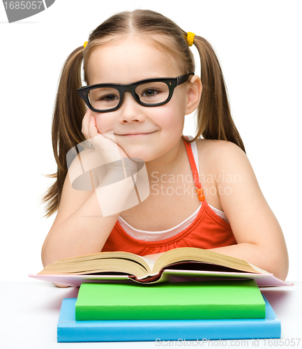 Image of Cute little girl with books