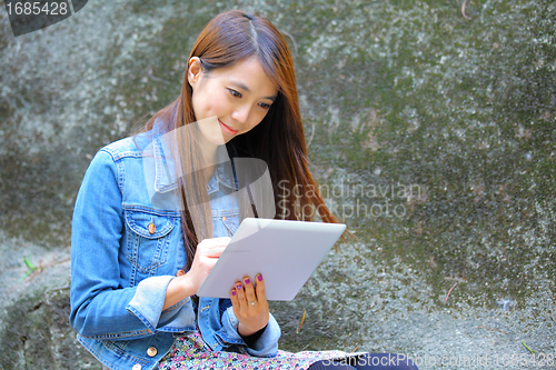 Image of beautiful asian woman using tablet computer