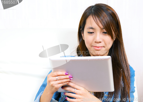 Image of young asian woman using tablet computer