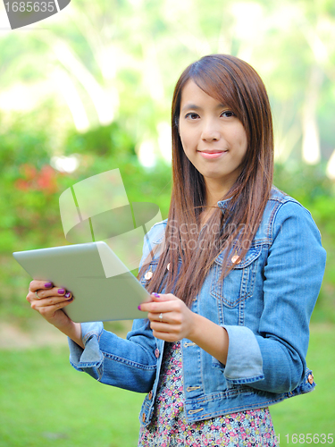 Image of young asian woman with tablet computer