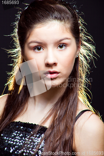 Image of beautiful  teenager girl with long dark hair on black
