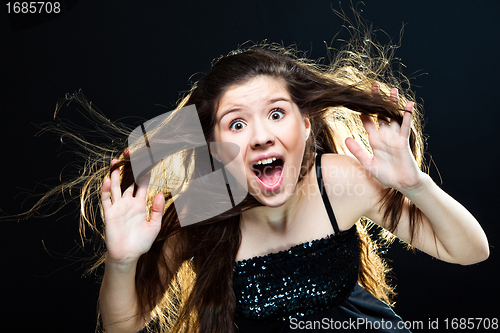 Image of cute girl with dark long hair shouting on black