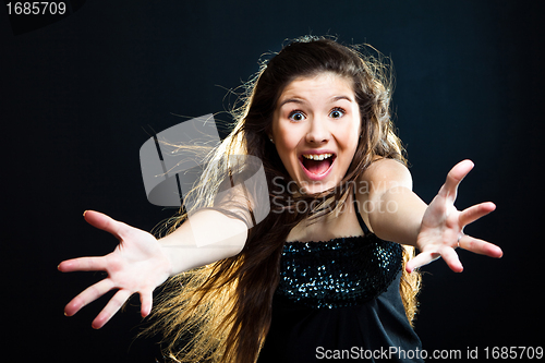 Image of cute girl with dark long hair shouting on black