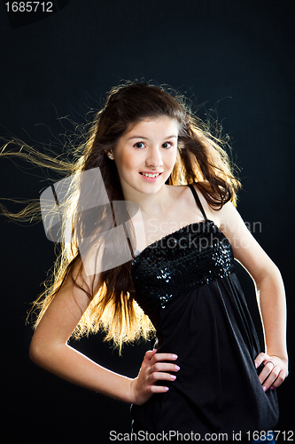 Image of cute teenager girl with  beautiful long dark hair  on black