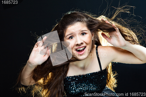 Image of  cute girl  going towards to wind and light on black