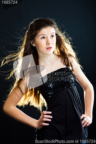 Image of cute teenager girl with  beautiful long dark hair  on black
