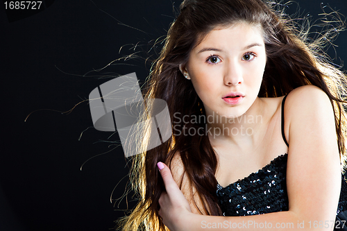 Image of cute teenager girl with  beautiful long dark hair  on black