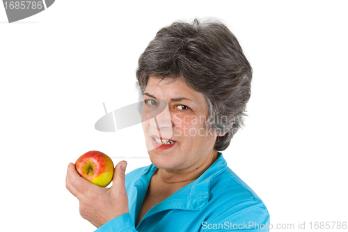 Image of Senior woman eating apple