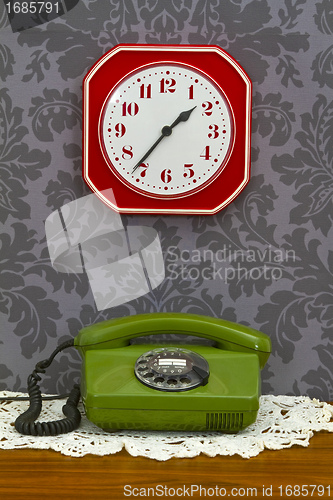 Image of Old fashioned telephone and clock