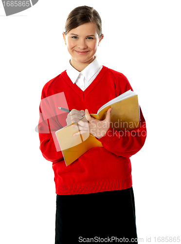Image of Caucasian student school girl writing on her notebook