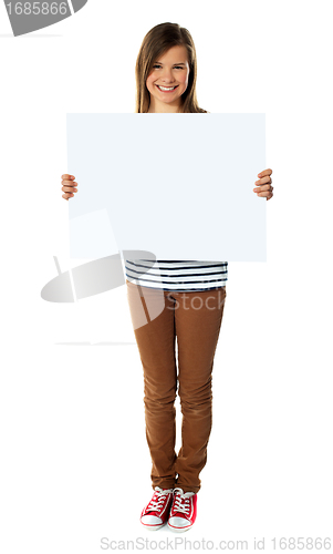 Image of Smiling girl holding empty white board