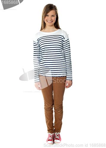 Image of Pretty teenager posing in front of camera, smiling