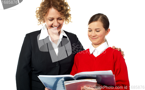 Image of Teacher helping teen student one on one