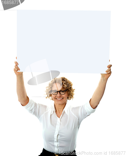 Image of Happy woman holding blank billboard