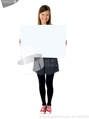Image of Attractive smiling cute girl holding blank poster